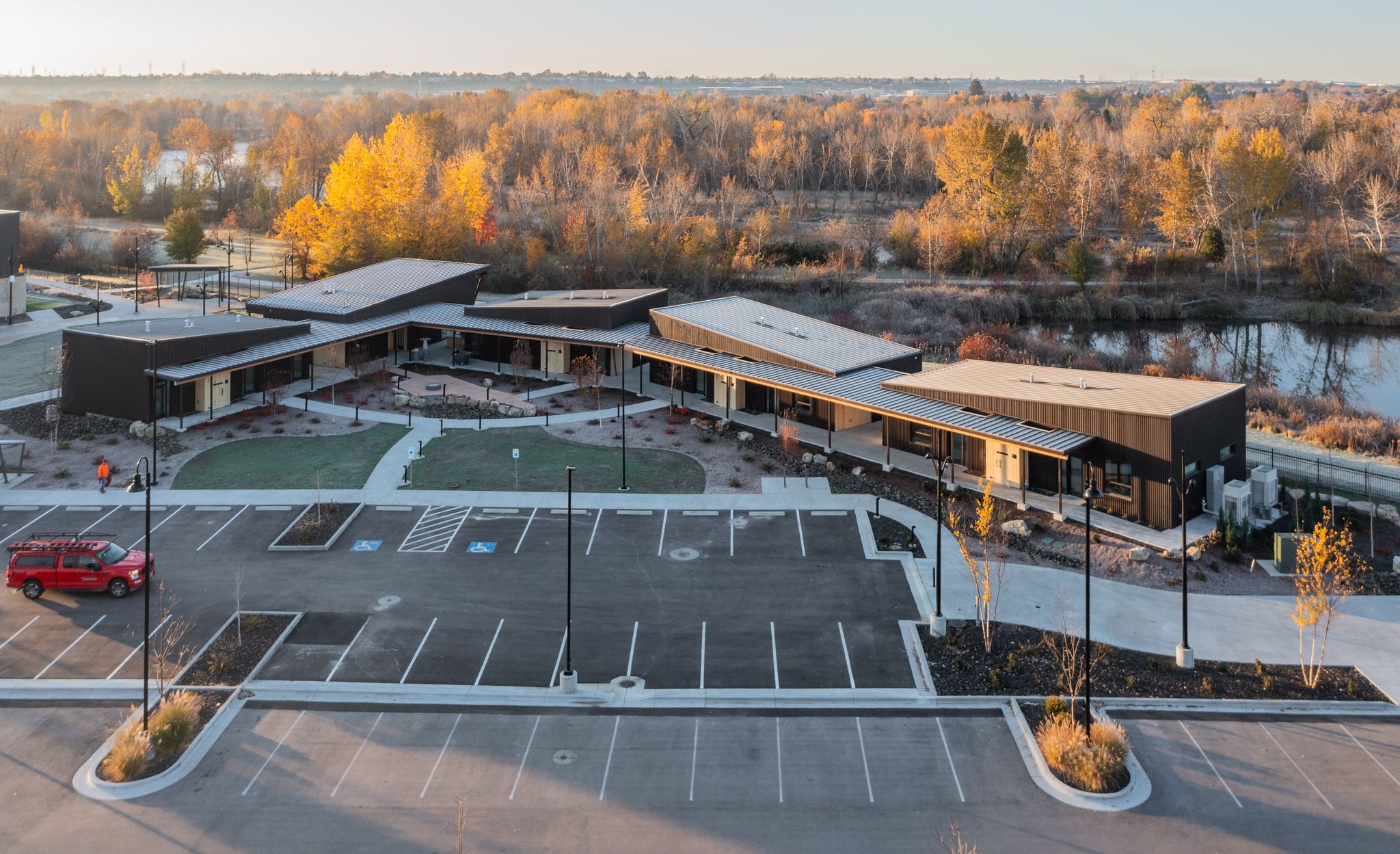 Aerial view of the participant lodging buildings on the Idaho Outdoor Fieldhouse campus, showing the parking lot and surrounding grounds.